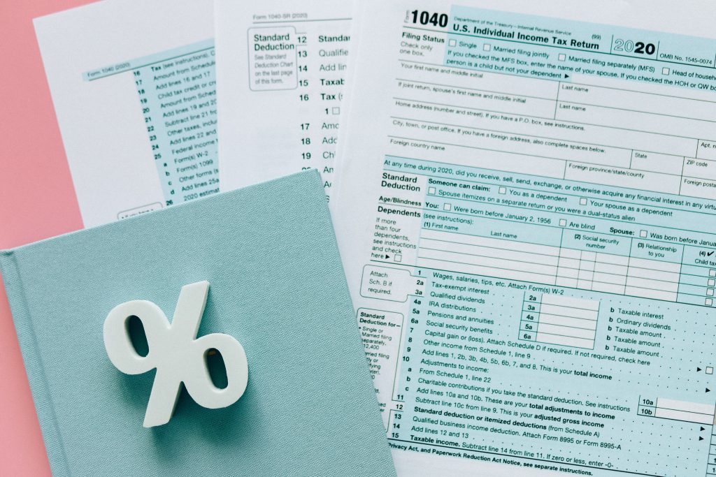 tax forms, account notebooks, percentage symbol